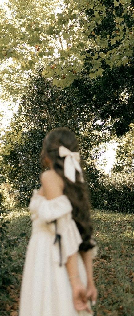Woman walking through sunlit woods